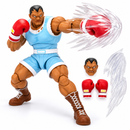 Street Fighter II Balrog collectible action figure displayed with gaming memorabilia
