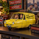 Del Boy and Rodney bobblehead figures displayed inside yellow Trotters Reliant three wheeled van with glossy finish.
